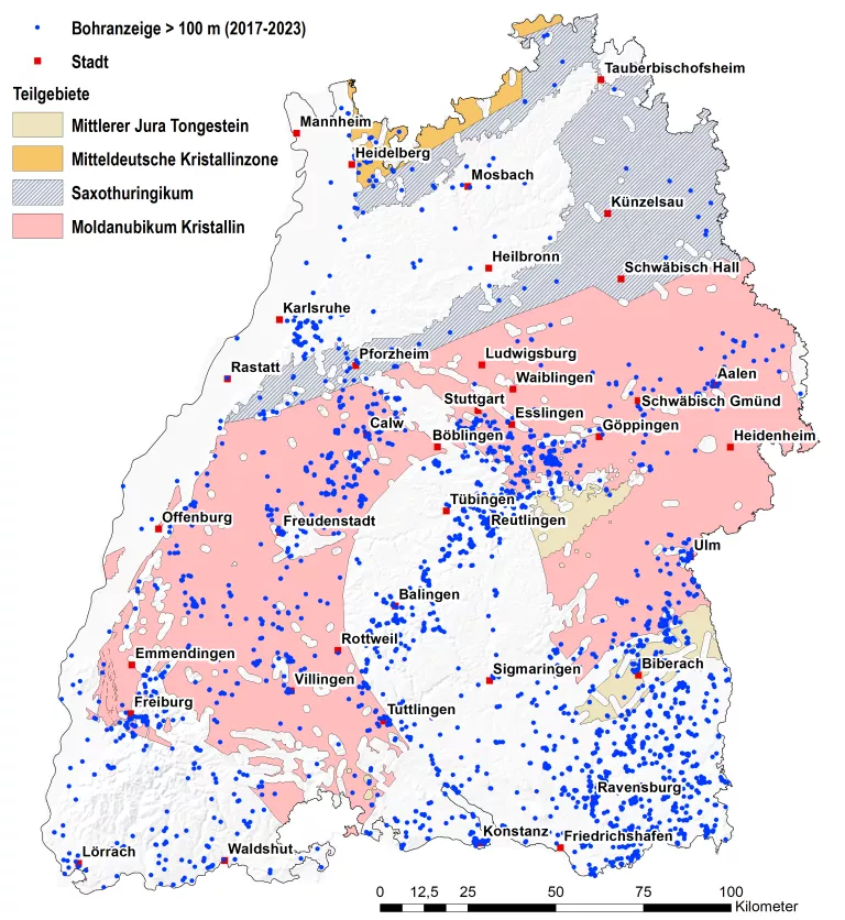 Es wird eine Karte von Baden-Württemberg dargestellt die in Bereichen unterschiedlich eingefärbt ist. Diese Einfärbung stellt die unterschiedlichen Wirtsgesteinstypen dar. Weiterhin werden größere Städte mit einem roten Punkt markiert, blaue Punkte zeigen auf der Karte die 2017-2023 angezeigten Bohrungen größer als 100 m Teufe.